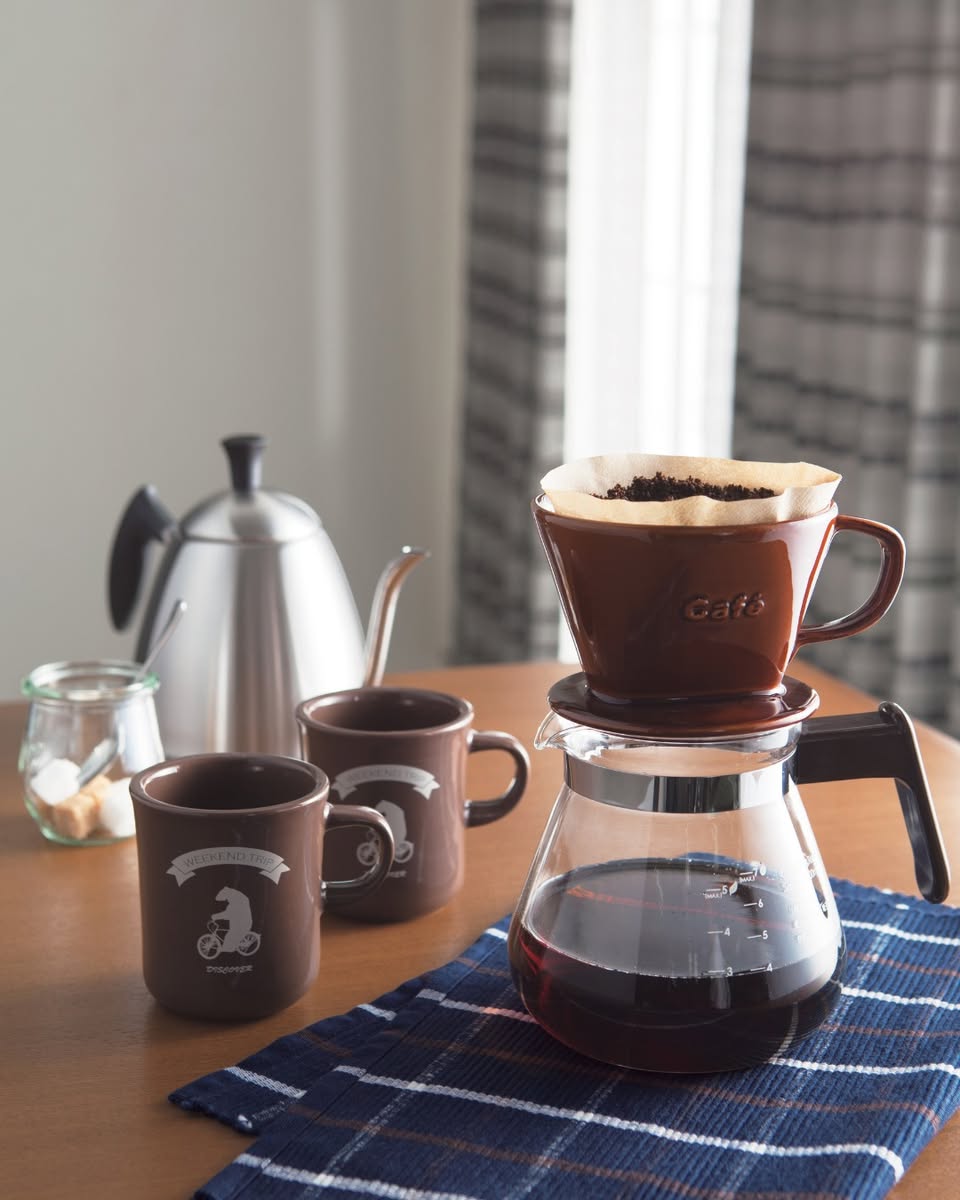 Brown ceramic pour-over dripper and Dutchman mugs with glass carafe
