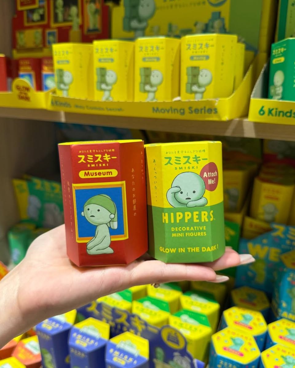 A wide view of a well-stocked bookstore aisle at Kinokuniya Singapore, with numerous books displayed on shelves.