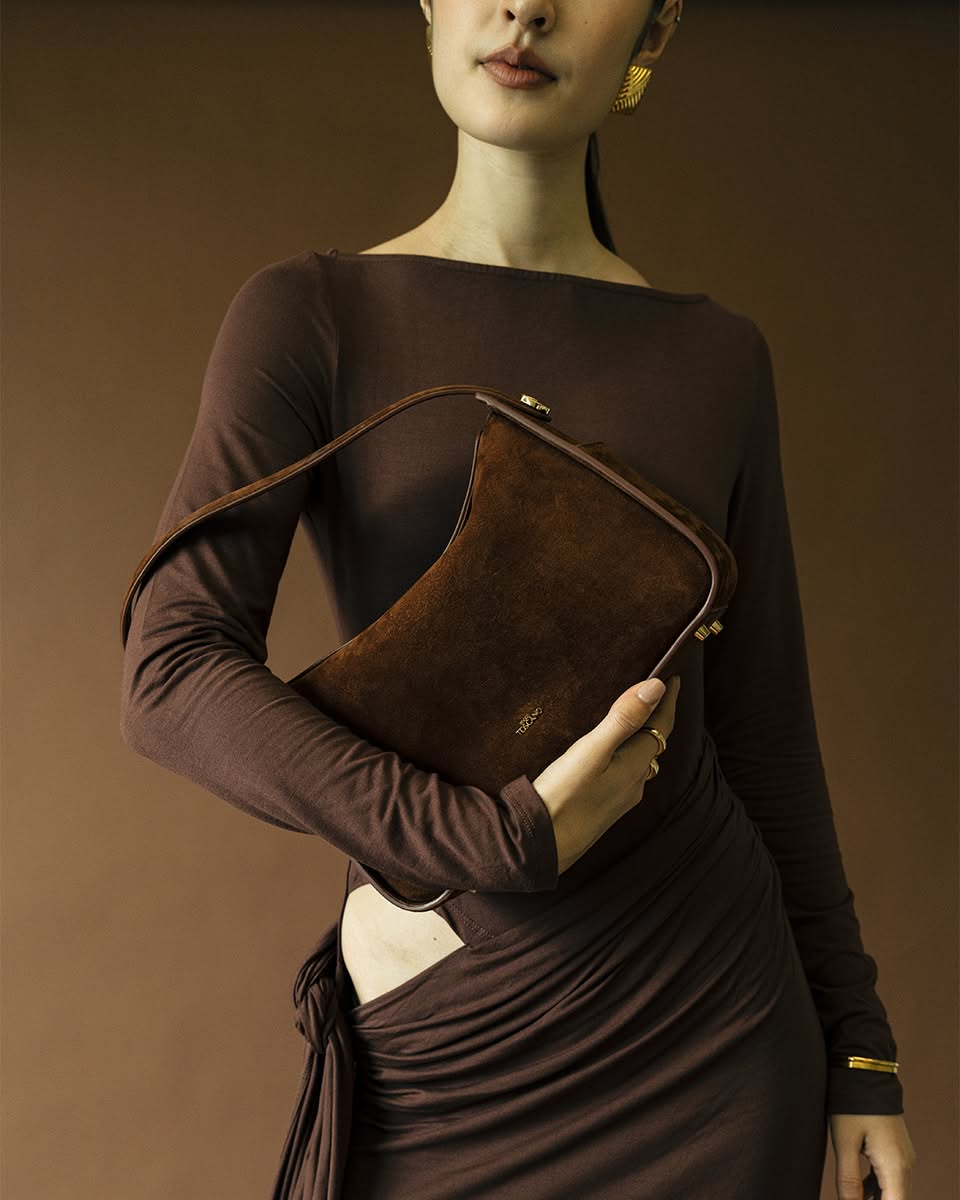 Lifestyle shot of a woman carrying the Luisa Hobo bag