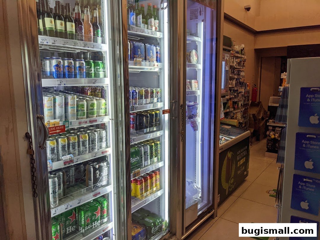 Refrigerated display cases filled with various beverages and products inside a 7-Eleven store.