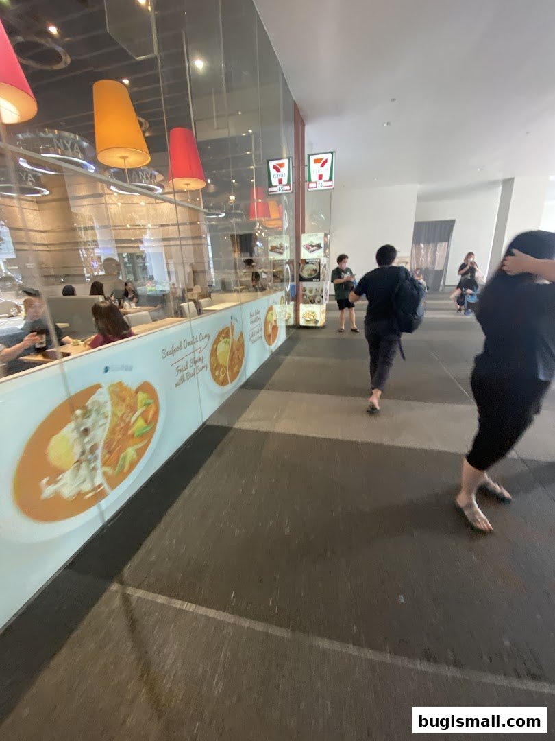 Exterior view of a 7-Eleven store with people walking by.