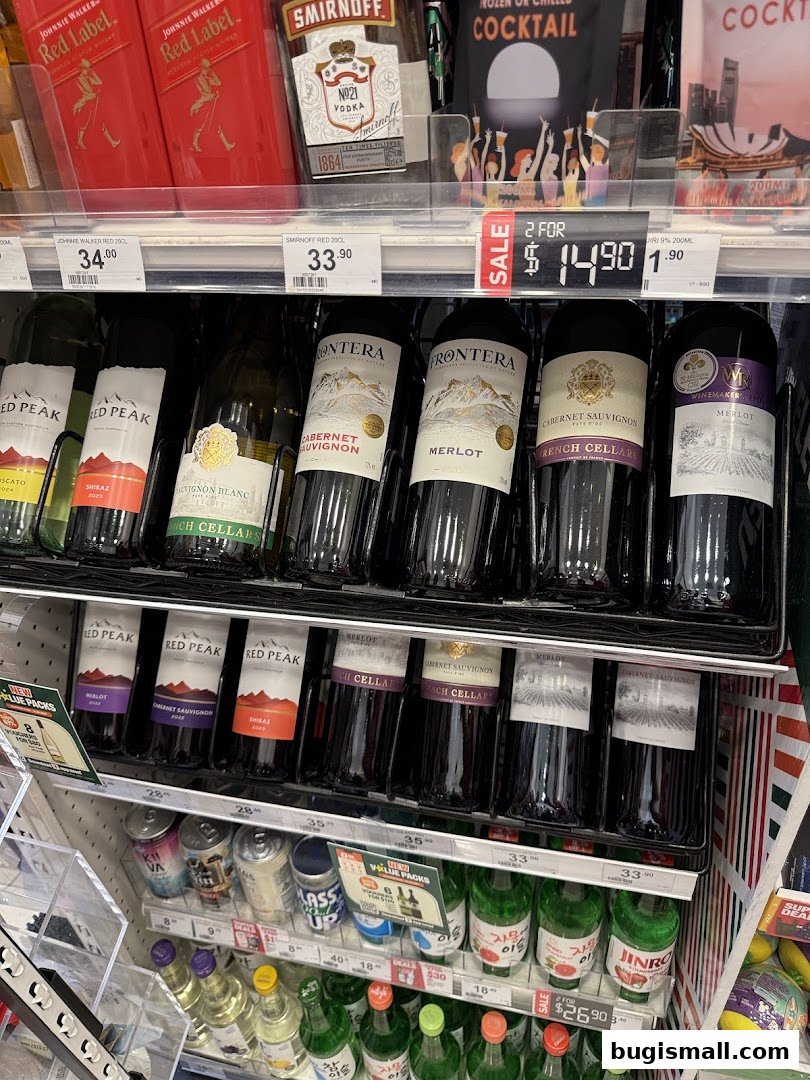 A display of various wine bottles and alcoholic beverages on shelves in a retail store.