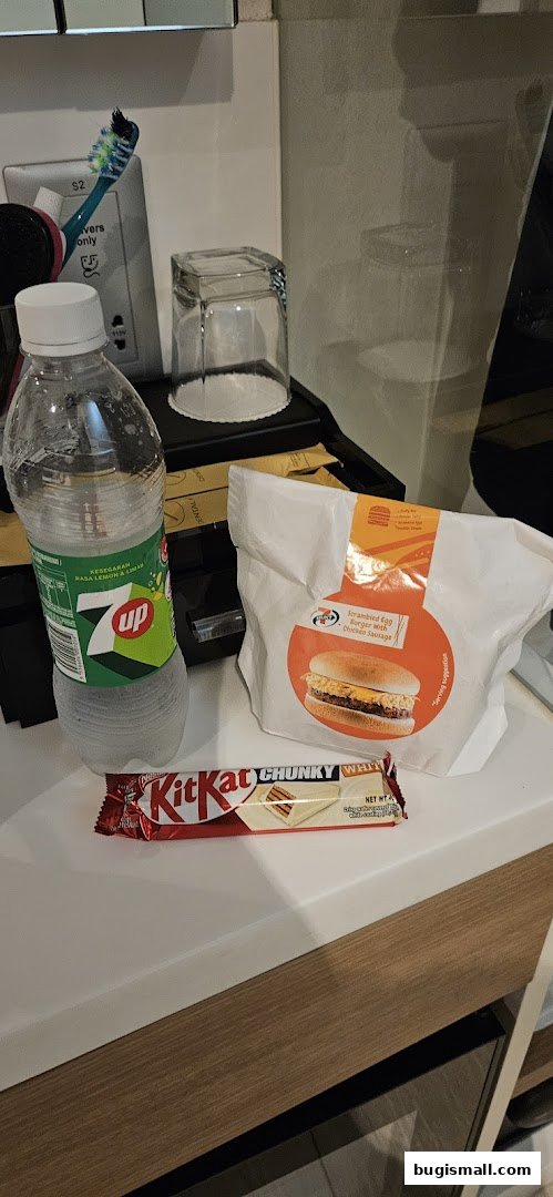 A 7-Eleven meal with a 7UP bottle, Kit Kat bar, and a burger.