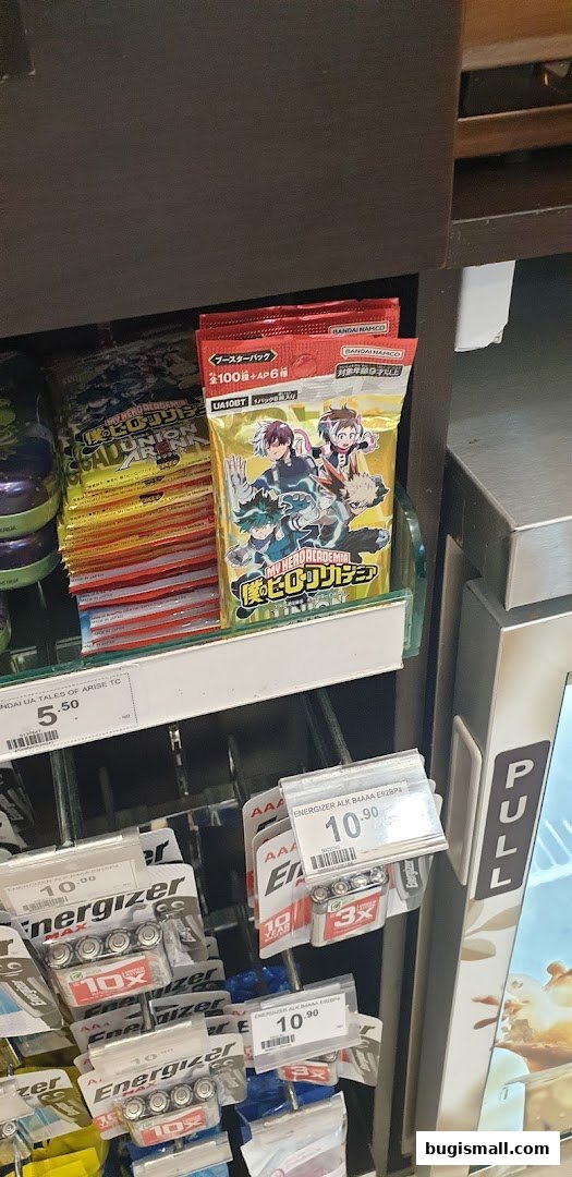 A display shelf in a 7-Eleven store featuring trading cards and batteries.