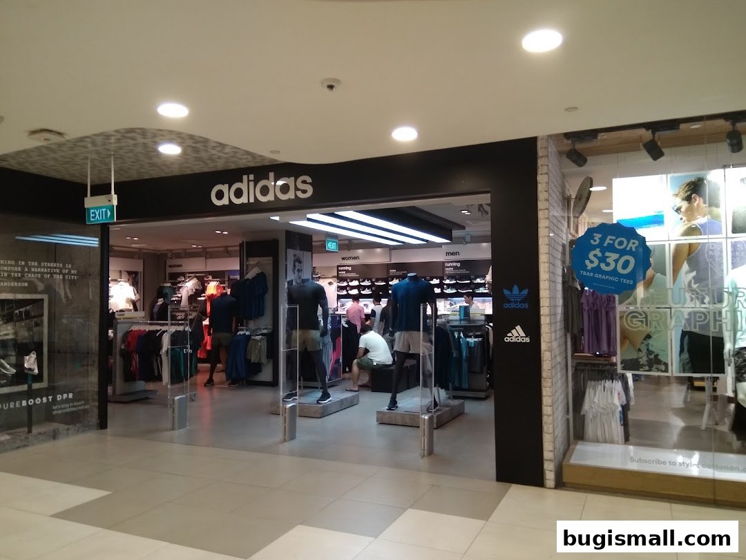 The entrance to an Adidas Originals store showcasing athletic apparel and a special offer.