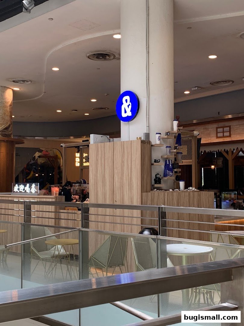 A modern tea shop with a prominent blue and white logo and wooden interior.