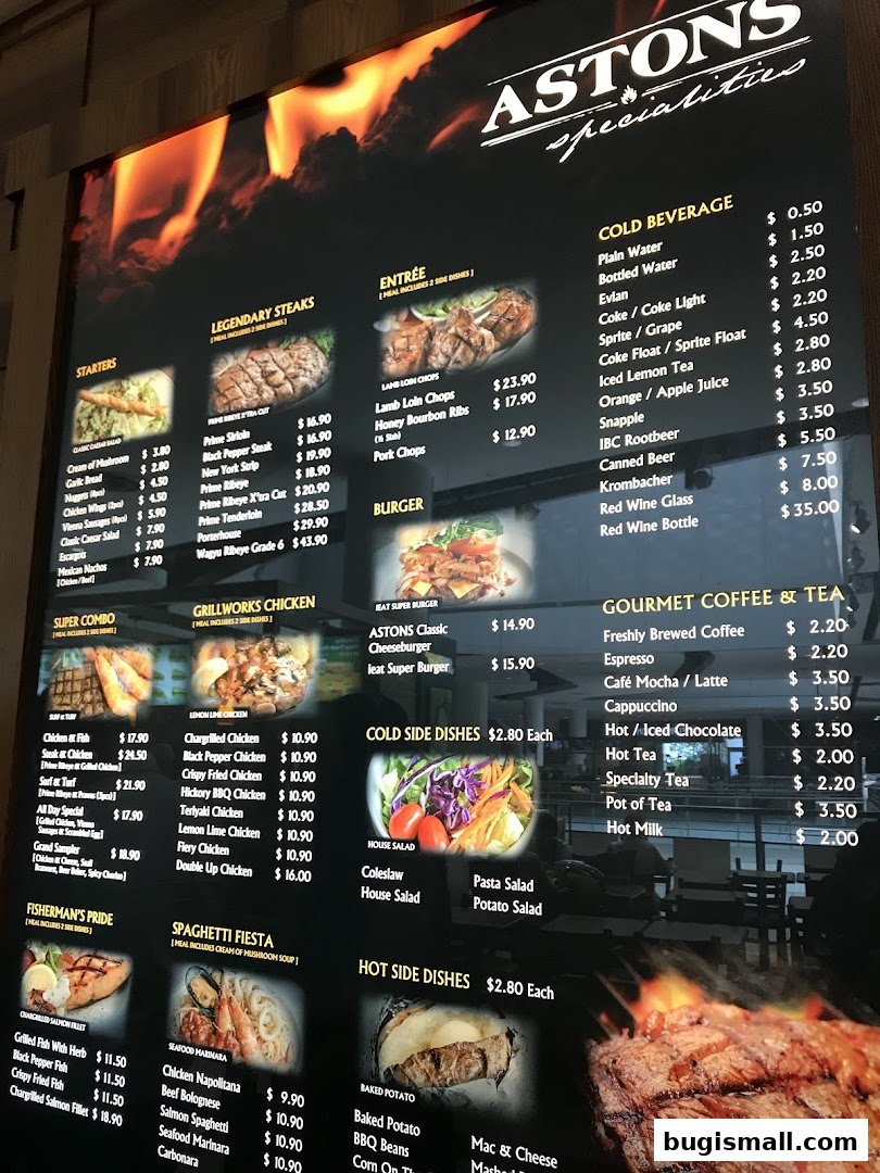 A menu board for ASTONS specialties featuring various steak, chicken, and pasta dishes, along with beverages.