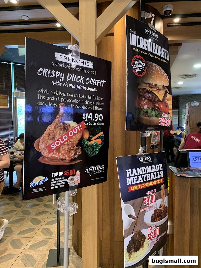 Advertisements for Astons restaurant featuring Crispy Duck Confit, Incrediburger, and Handmade Meatballs.