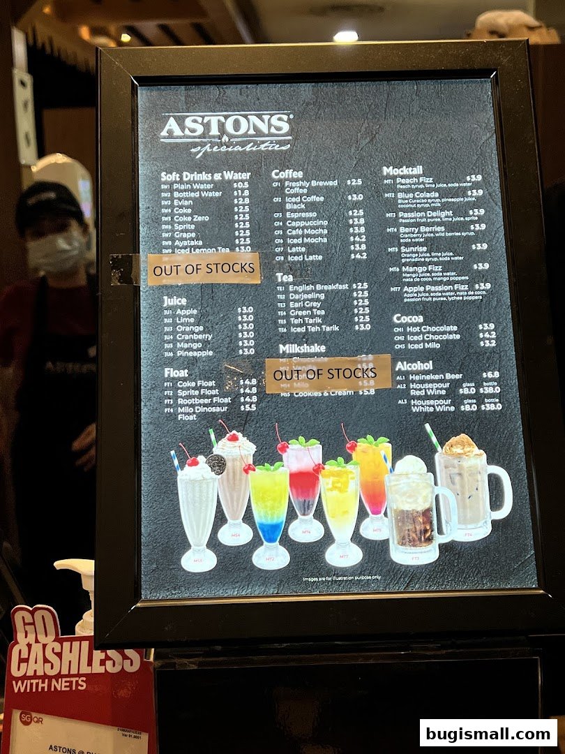 A menu board for ASTONS Specialities featuring drinks like coffee, tea, mocktails, milkshakes, and alcohol.