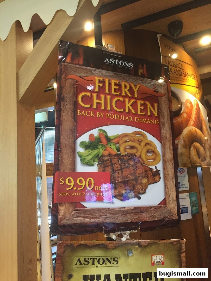 A promotional sign for Astons' Fiery Chicken dish, priced at $9.90.