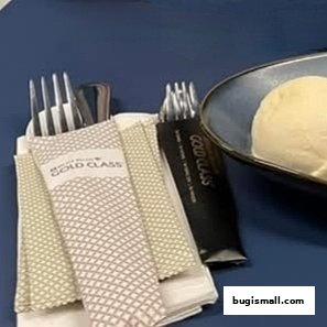 Cutlery and a dessert are presented on a table, with 'GOLD CLASS' branding visible.