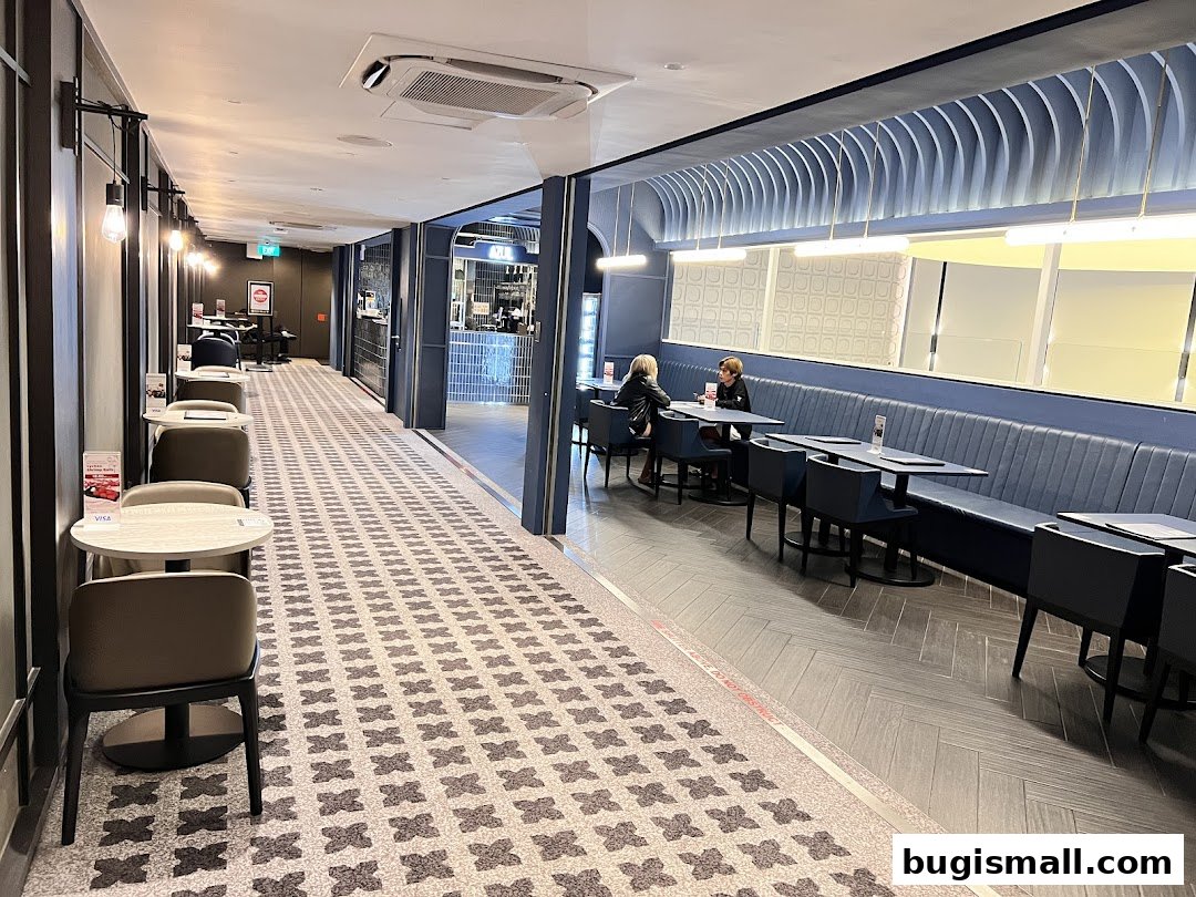 Interior view of a modern cafe with seating areas and a counter.
