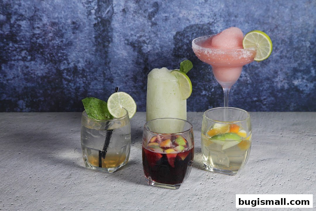 A selection of four colorful and refreshing cocktails garnished with lime and mint.