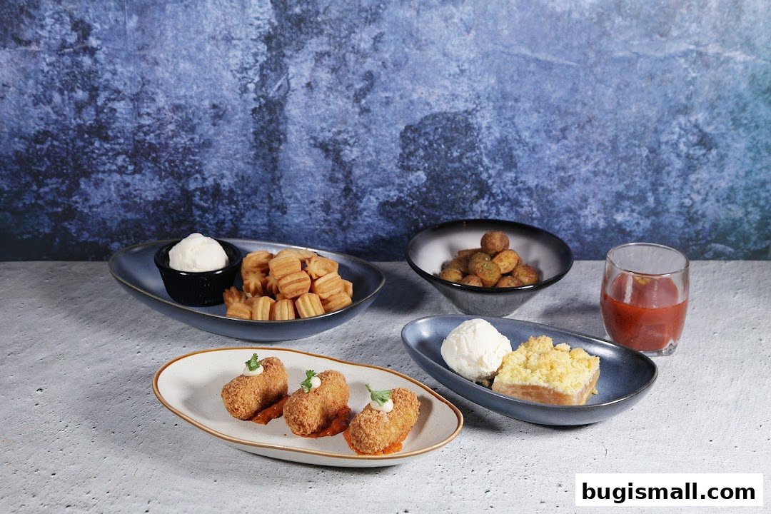 A spread of appetizers and desserts, including croquettes, churros with dip, and apple crumble with ice cream.