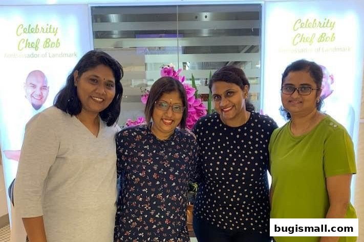 Four women smiling in front of a backdrop featuring Celebrity Chef Bob.