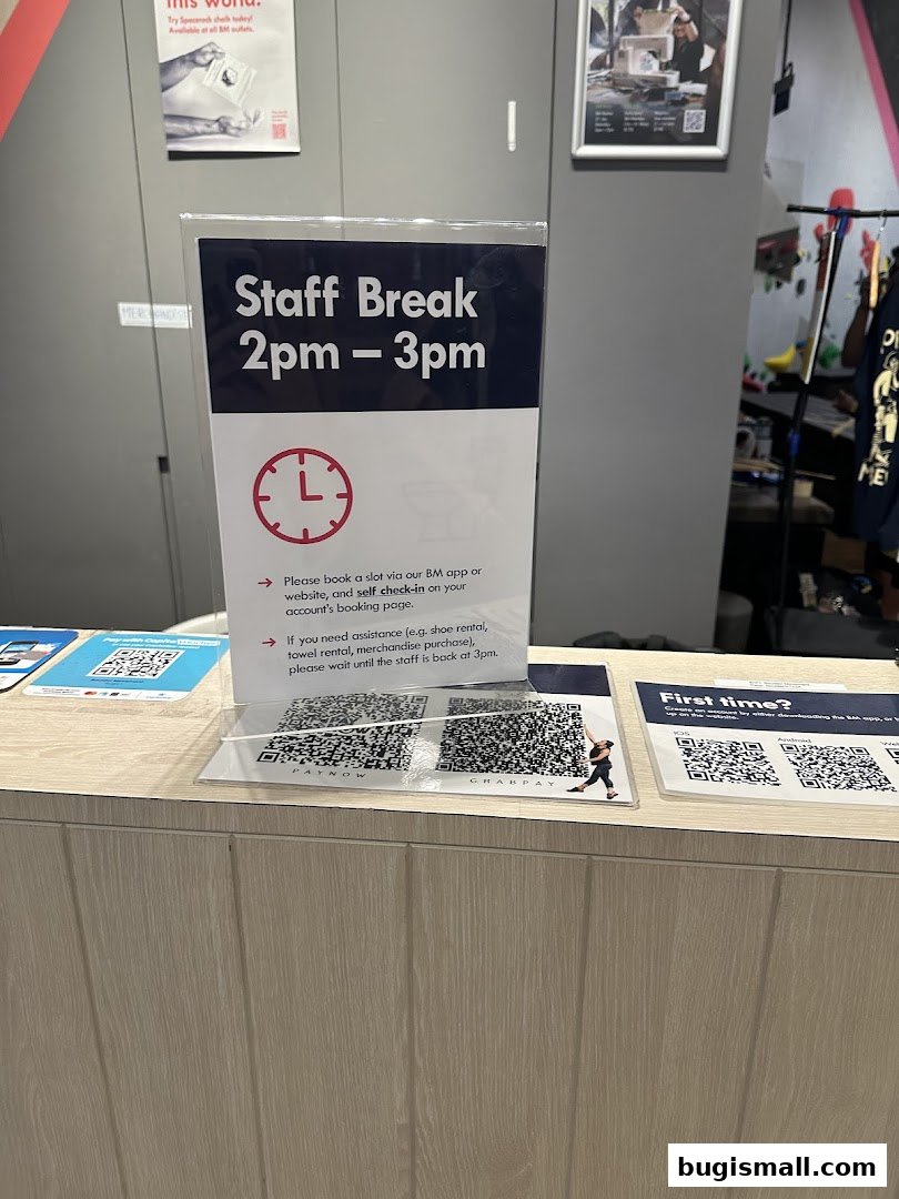 A sign indicating a staff break from 2pm to 3pm with instructions for customers.