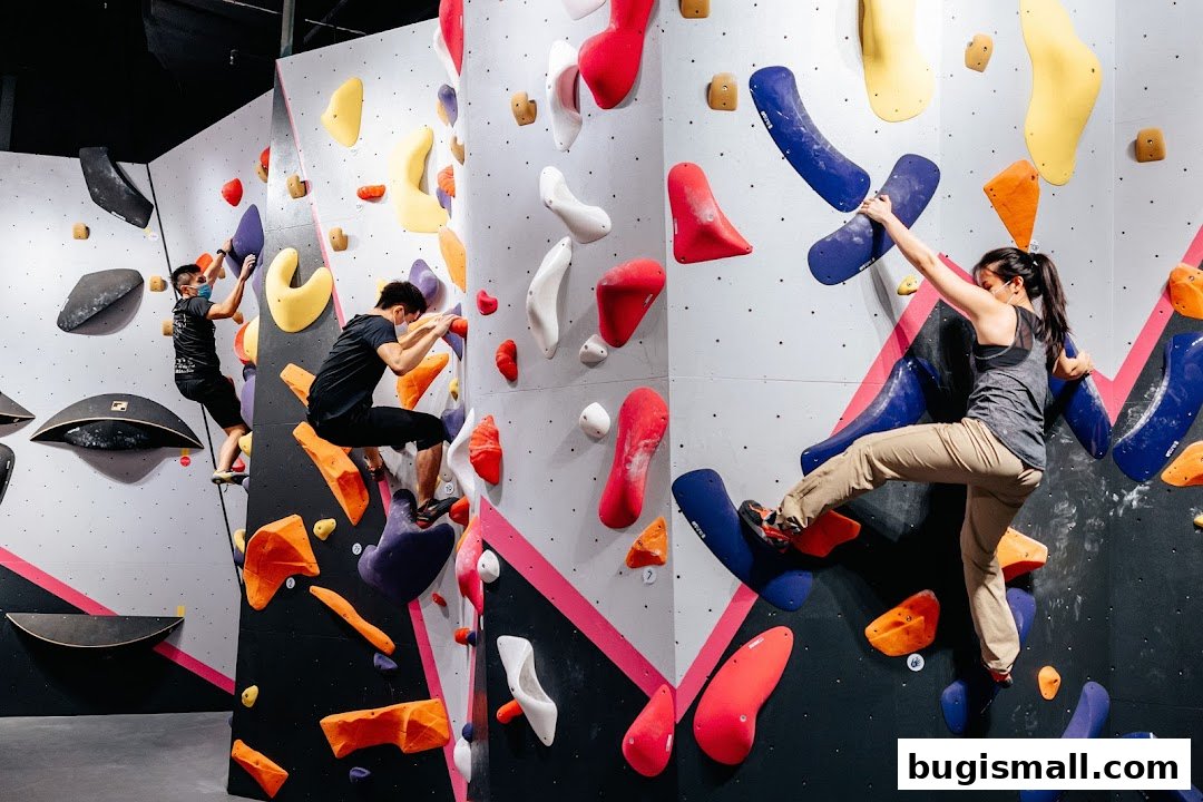 People bouldering on colorful climbing walls with various holds.