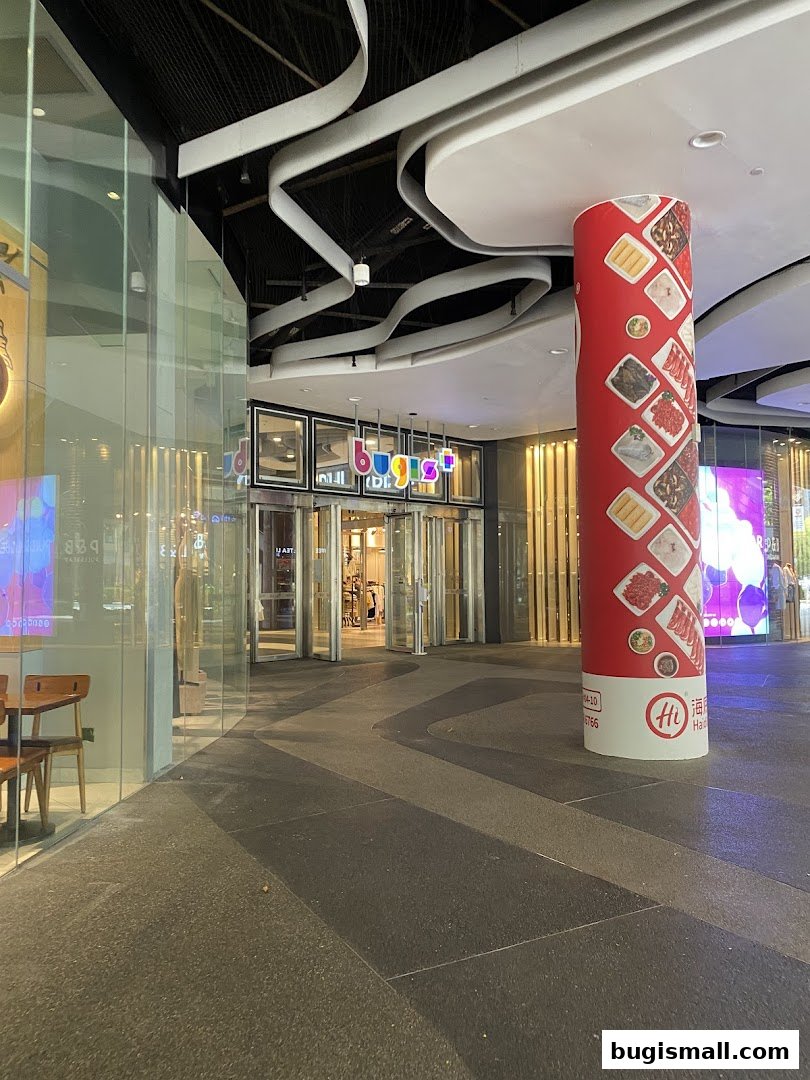 The entrance to Boulder Movement Bugis with colorful signage and a decorative pillar.
