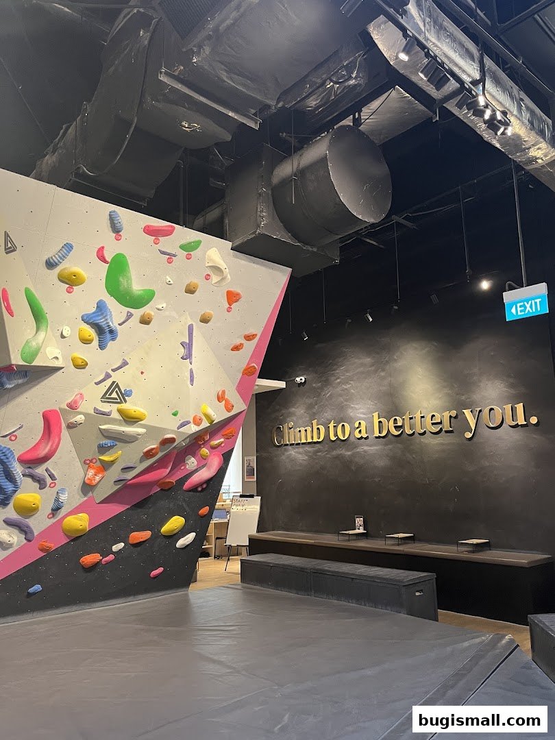 Interior of a bouldering gym with climbing walls and seating area.