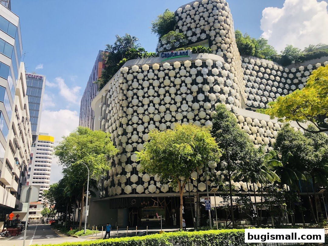 A striking modern building with a unique honeycomb facade and lush greenery.