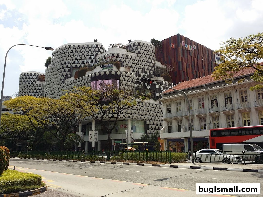 A view of the CapitaMalls Asia Limited - Bugis building with its unique facade and surrounding street.