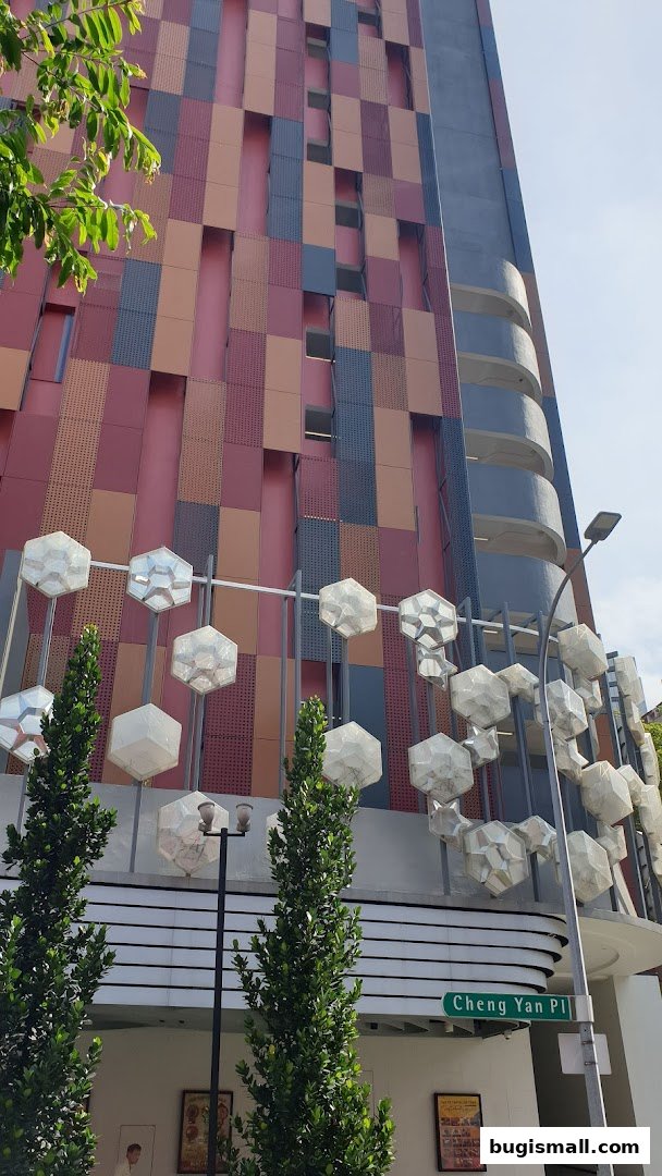 A modern building facade with colorful panels and geometric light fixtures.