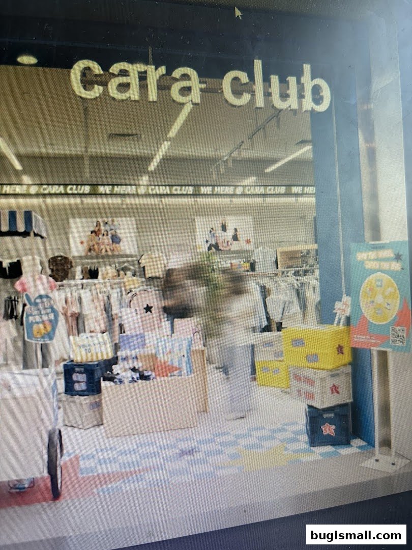 The entrance of Cara Club, a clothing store, displaying merchandise and promotional materials.