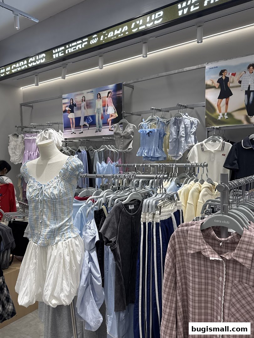 A well-lit clothing store interior showcasing a variety of trendy women's apparel on display racks.