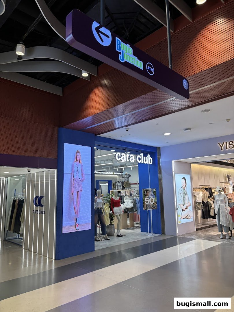The Cara Club fashion store entrance with mannequins displaying outfits and a sale sign.