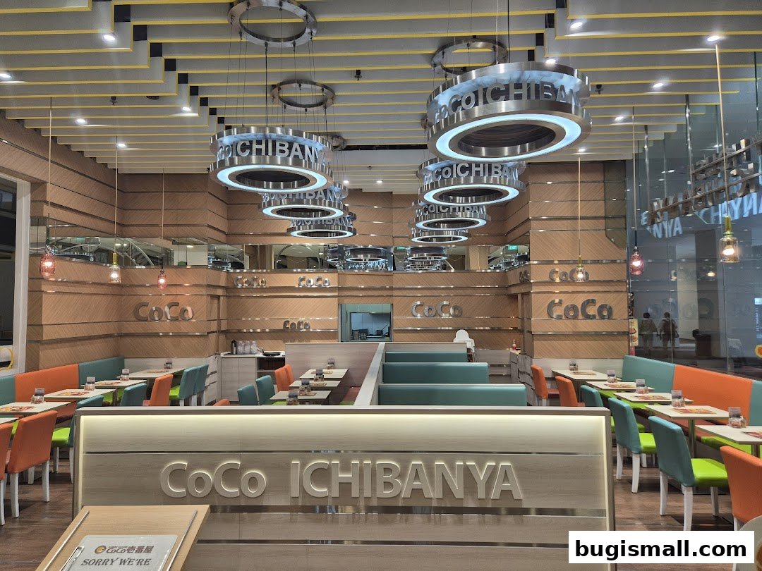 Interior view of CoCo Ichibanya restaurant with colorful seating and prominent branding.