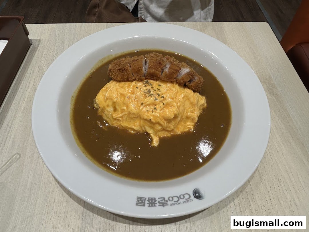 A delicious plate of Japanese curry with omelette and fried pork cutlet.
