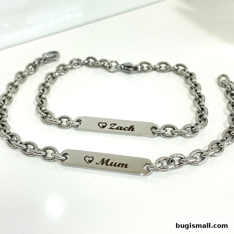Two silver bracelets with personalized name tags, one reading 'Zach' and the other 'Mum'.