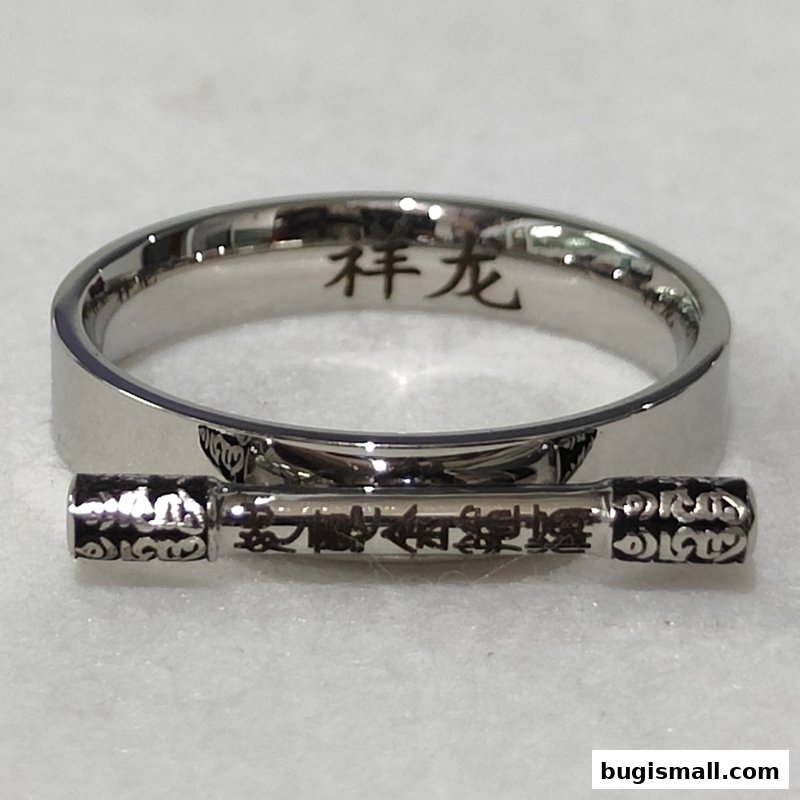 A silver ring with Chinese characters and a decorative cylindrical charm with intricate patterns.