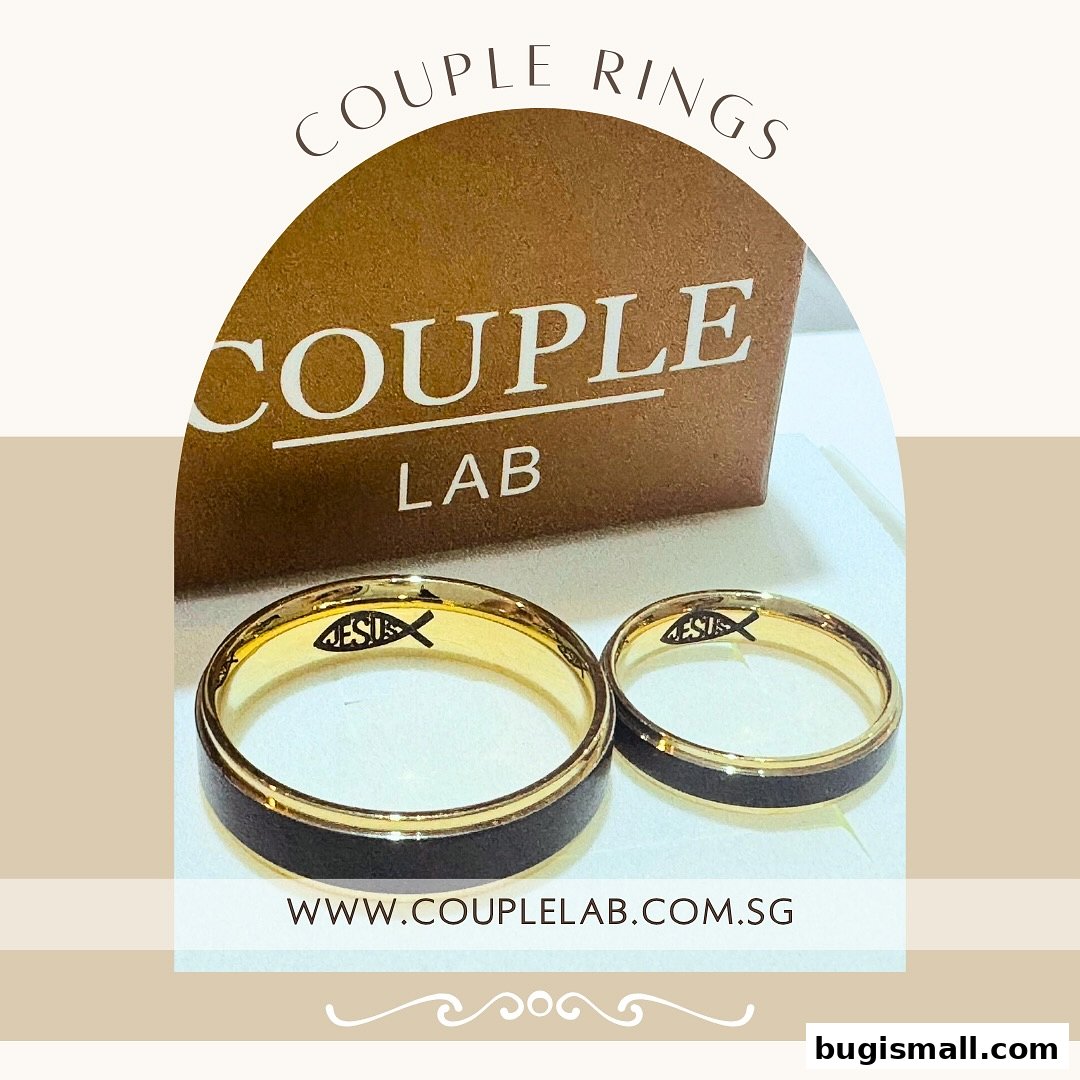 Couple Lab showcases a pair of elegant gold and black wedding rings with a Christian fish symbol inside.