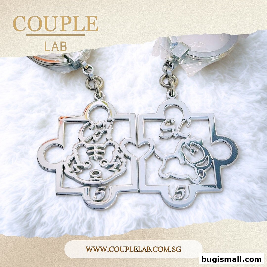 Close-up of two silver puzzle piece keychains with custom engravings and animal designs.