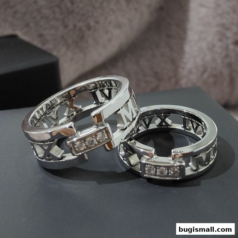 Two elegant silver rings with Roman numerals and small diamonds are displayed.