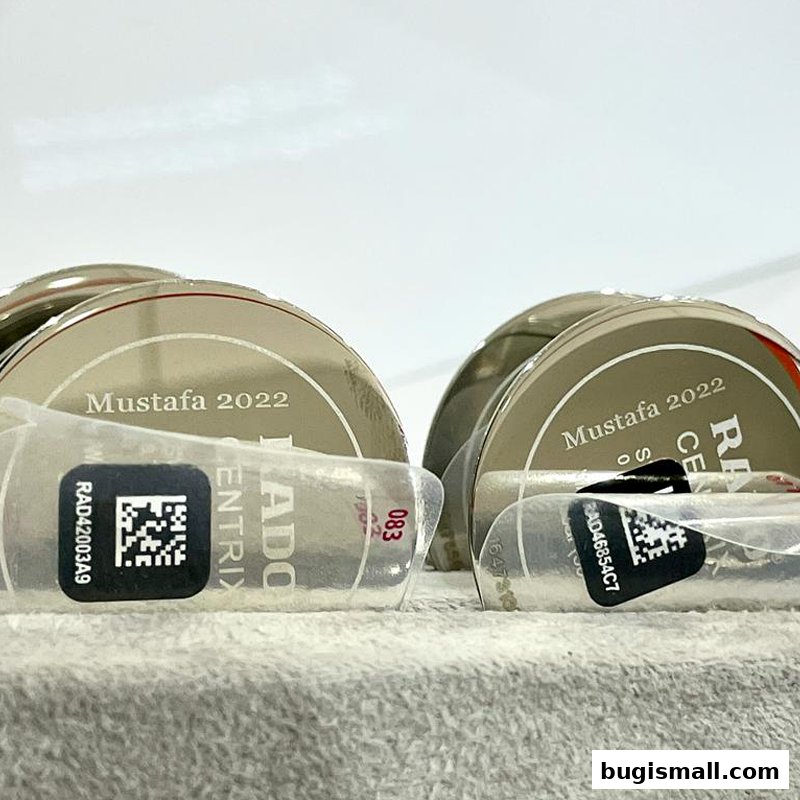 Close-up of Rado watches with 'Mustafa 2022' branding and QR codes.
