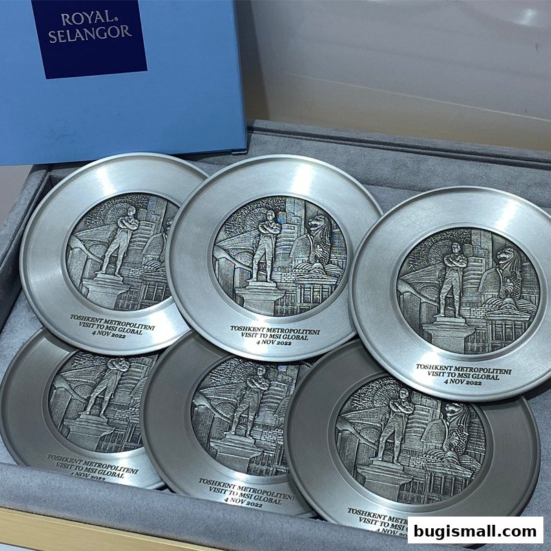 A set of six pewter coasters with embossed cityscapes and figures, presented in a Royal Selangor box.