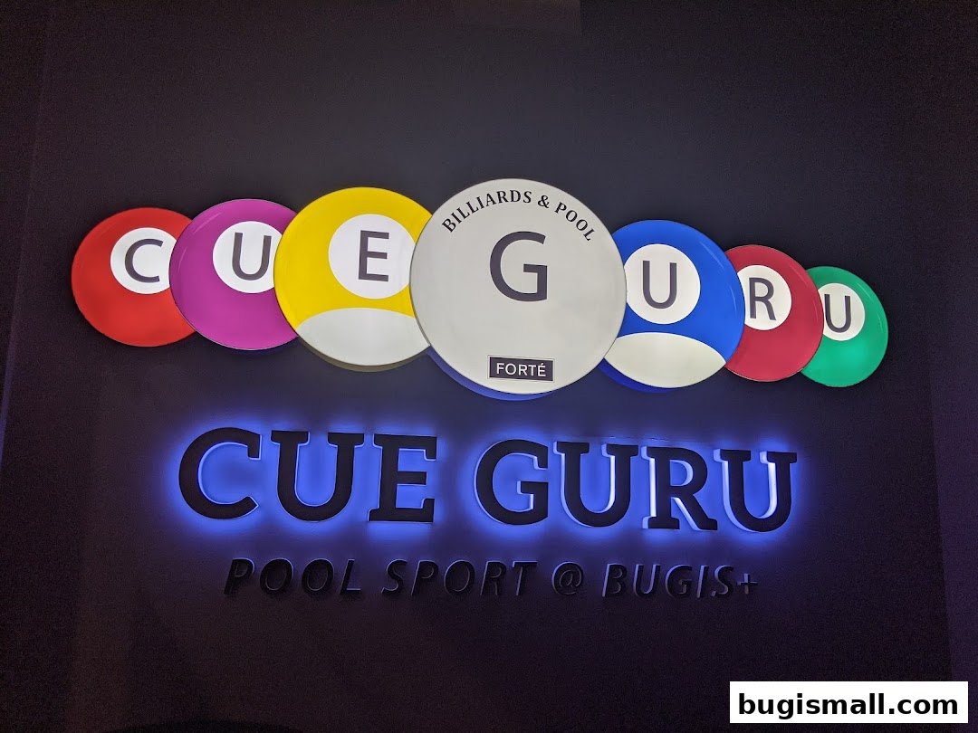 The Cue Guru logo features colorful billiard balls spelling out the name, with neon blue lighting.