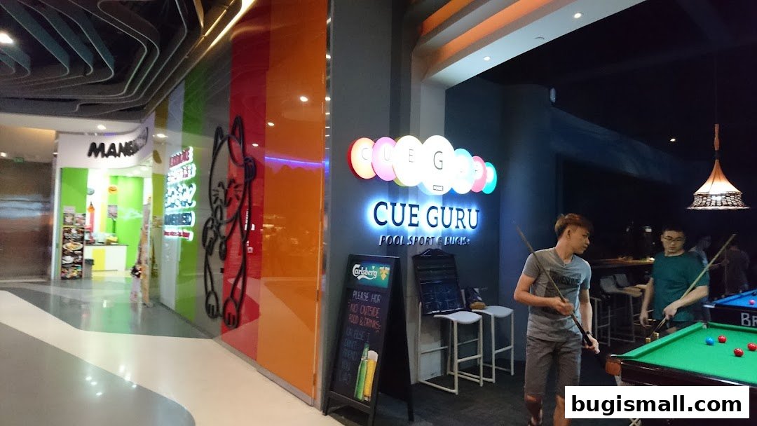 People playing pool at Cue Guru, a pool sport and bar.