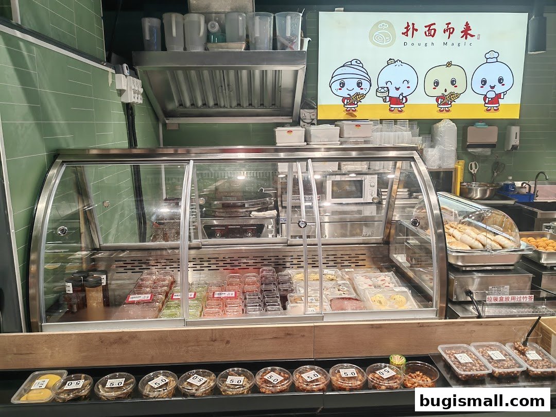 A display counter filled with various food items and a sign with cartoon characters.