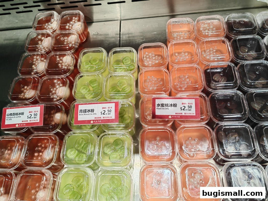 A display of various colorful ice jellies in clear plastic containers with price tags.