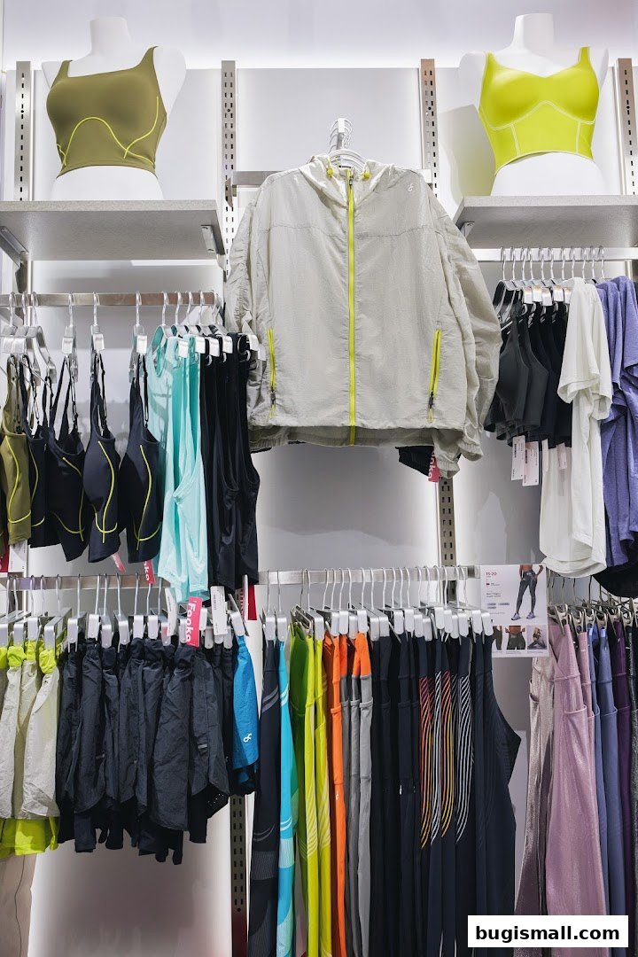 A display of athletic wear including sports bras, jackets, shorts, and leggings in various colors.