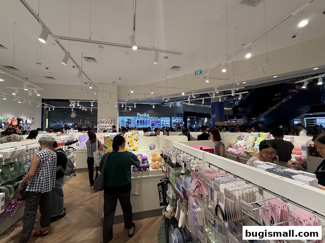 Interior view of a busy Flying Tiger Copenhagen store with customers browsing merchandise.