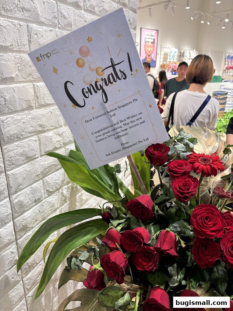 A congratulatory bouquet with a card placed in front of a store interior.