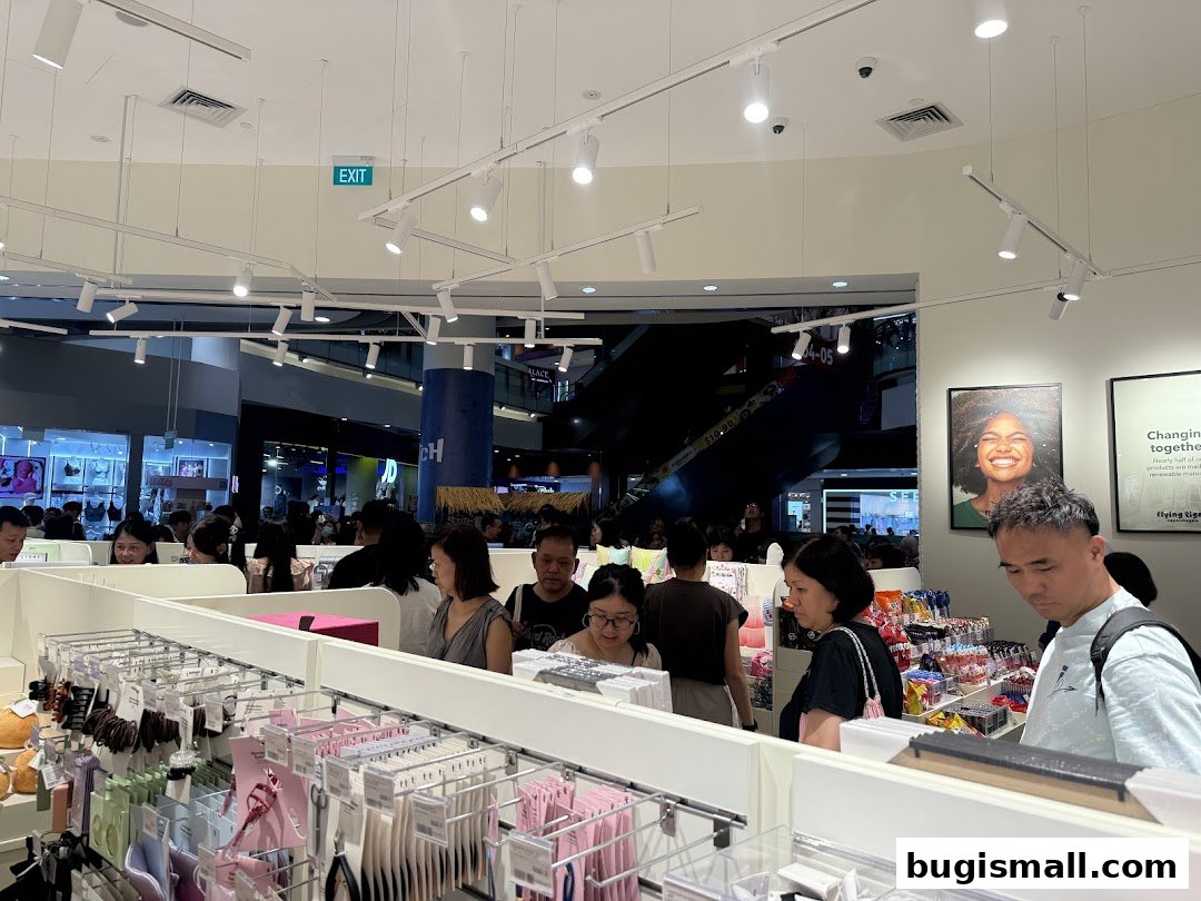 Interior view of a busy Flying Tiger Copenhagen store with customers browsing merchandise.