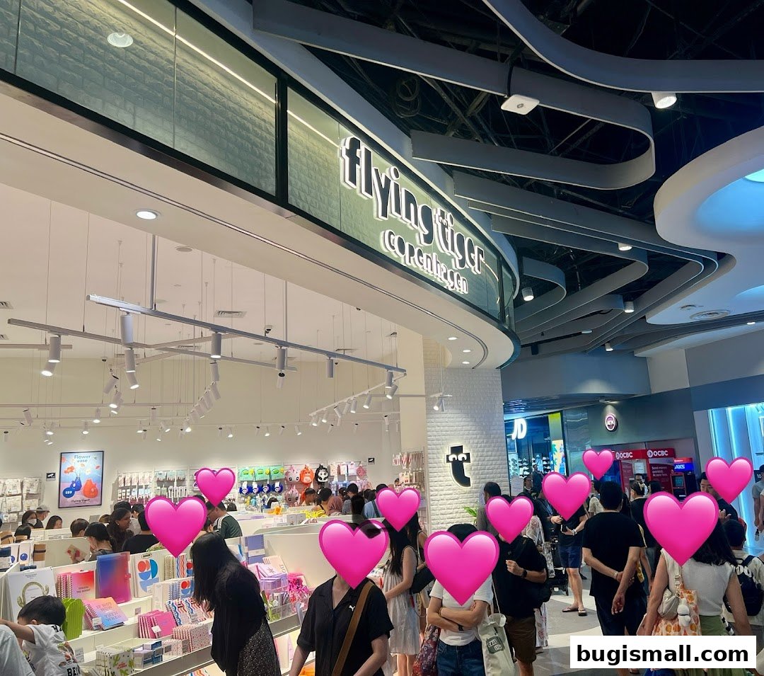 Interior view of a busy Flying Tiger Copenhagen store with many shoppers.
