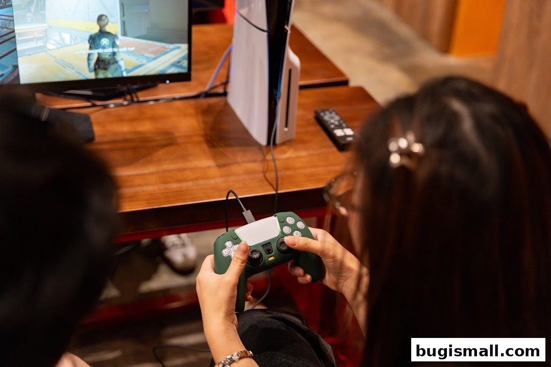 Two people playing video games on a console with controllers and a monitor.