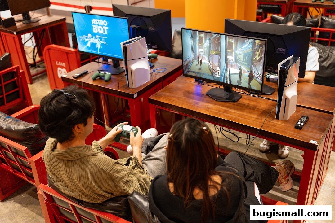 Two people playing video games on consoles at a gaming cafe.