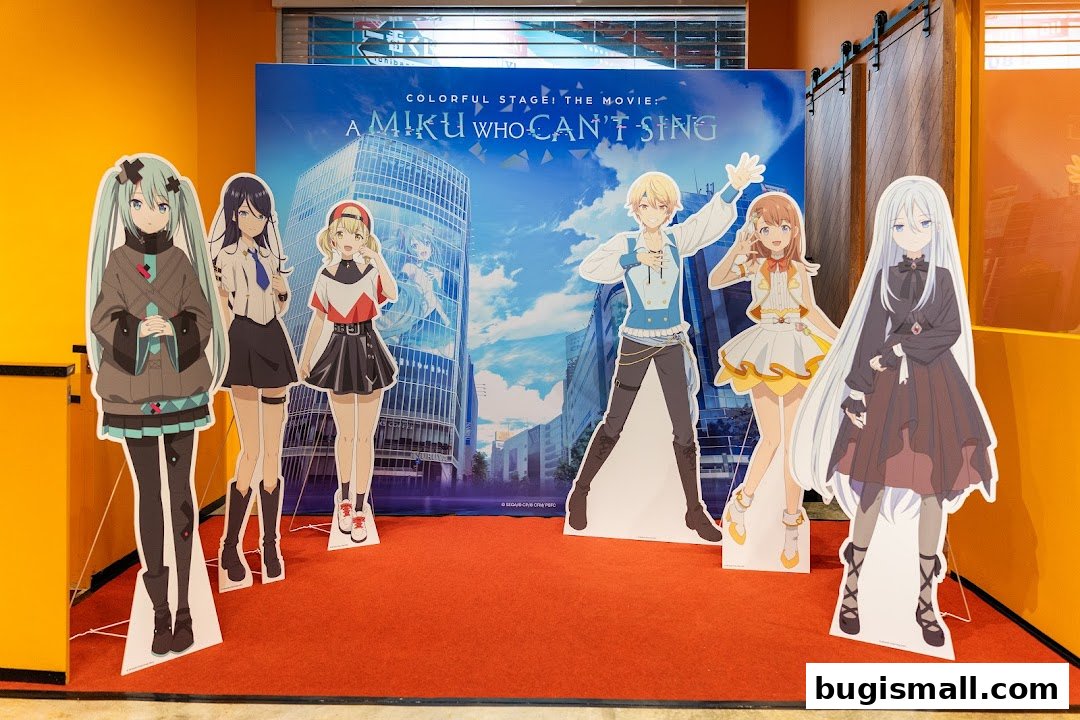 Cardboard cutouts of anime characters stand in front of a movie poster.